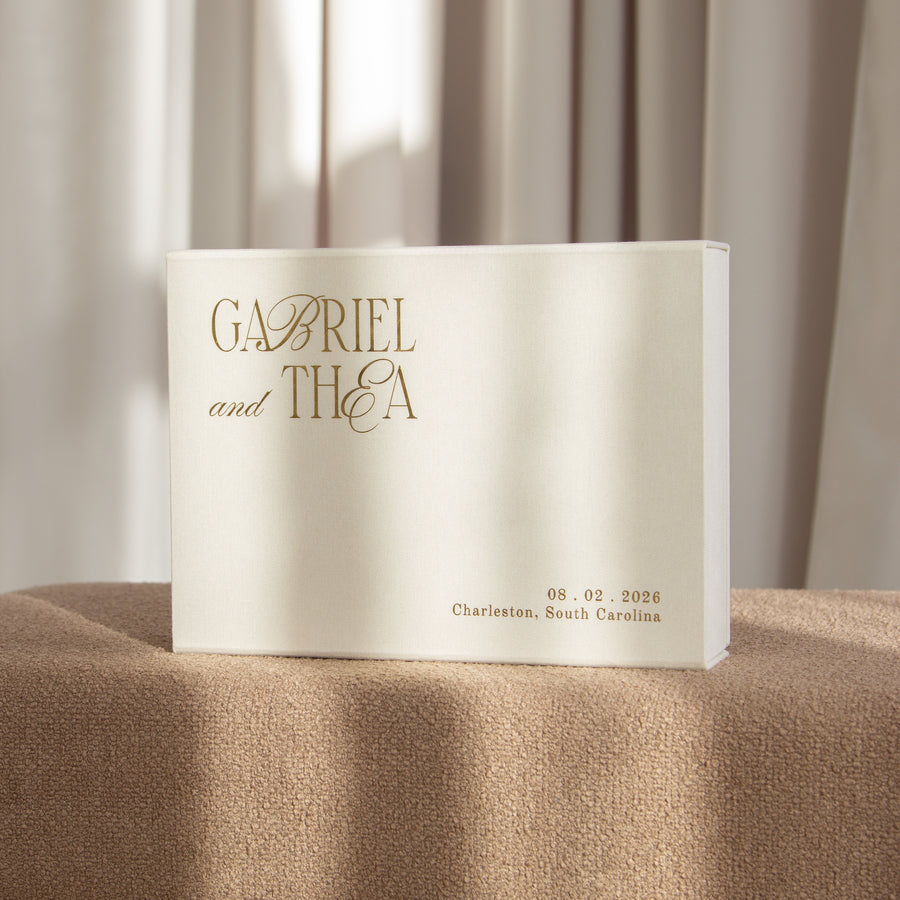 White keepsake box with gold text on a brown surface