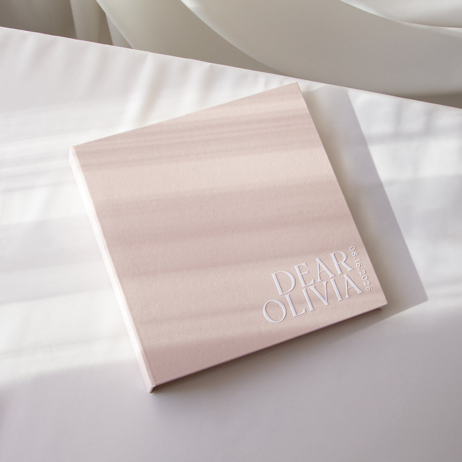 Pink Letters to the bride album with 'Dear Olivia' embossed on it, on a white surface. 
